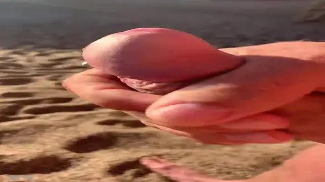 Horny guy jerks off in the open air by the beach 